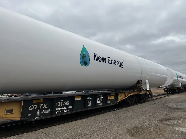 GreenER™ LNG tank with the New Energy logo, loaded on a rail flatcar