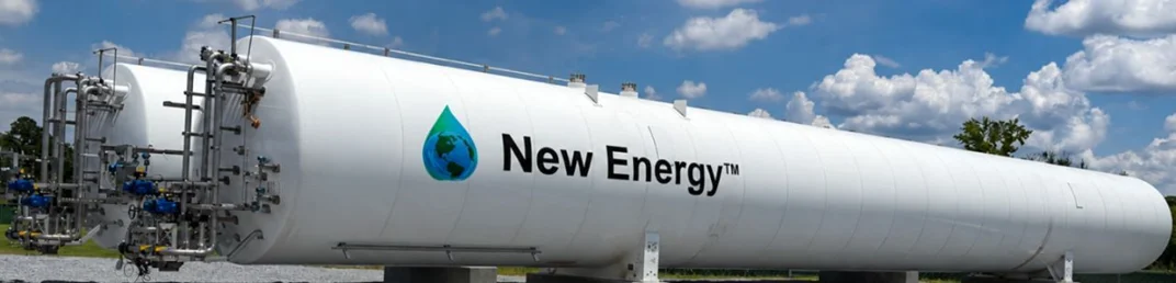 A long white horizontal cryogenic tank on concrete saddles under a blue sky, the New Energy globe-and-drop logo painted on its side, piping and valves at the near end