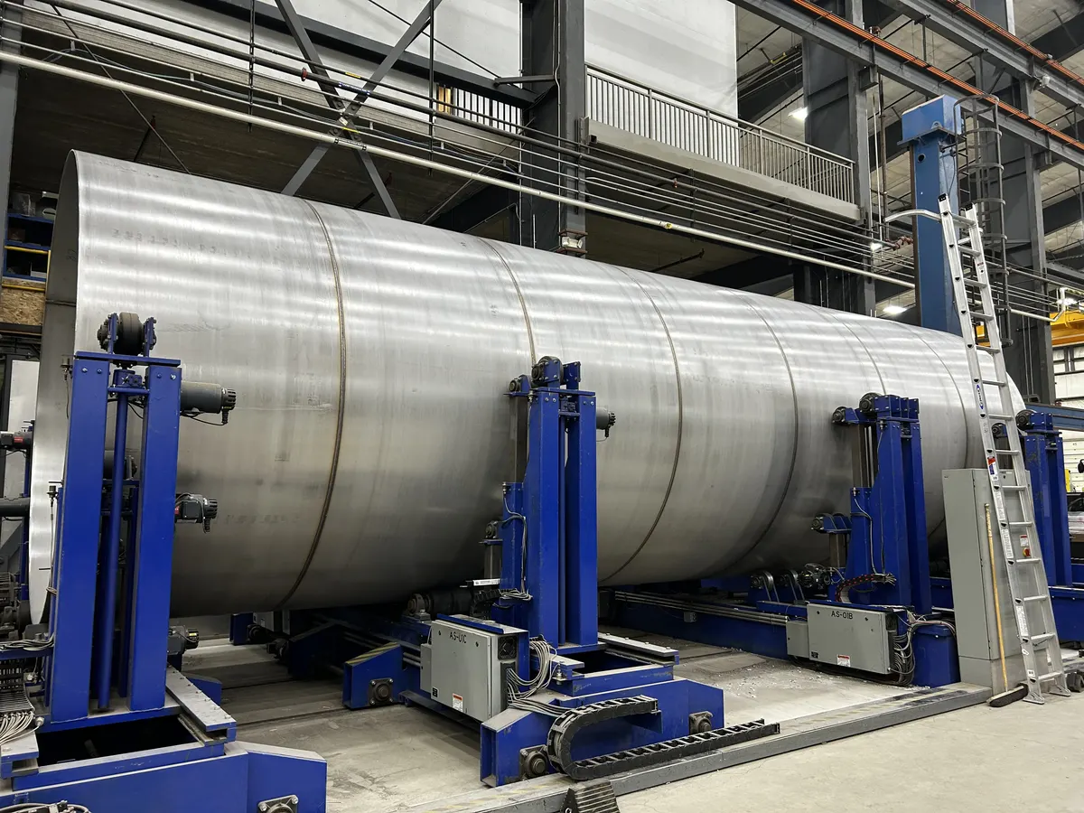 GreenER tank shell rotating on Chart Industries' blue fabrication positioners inside a clean, well-lit shop